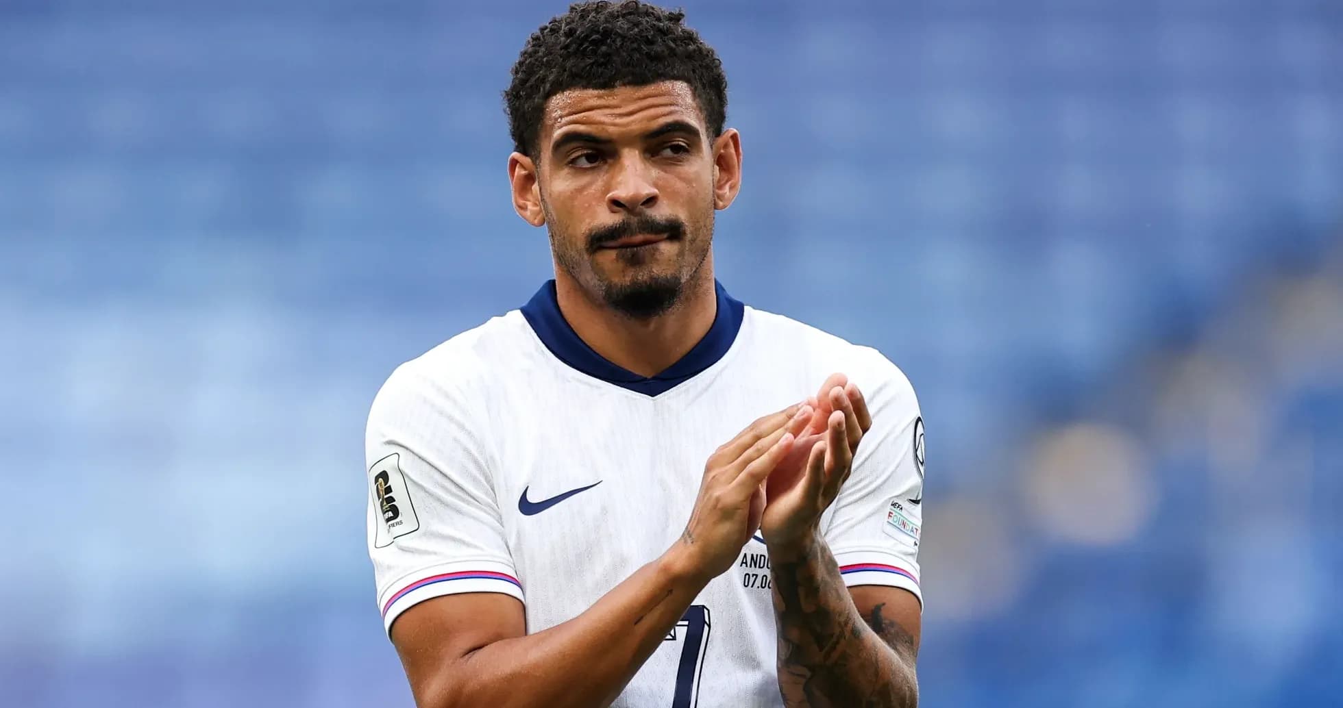 Player applauding while wearing national team jersey