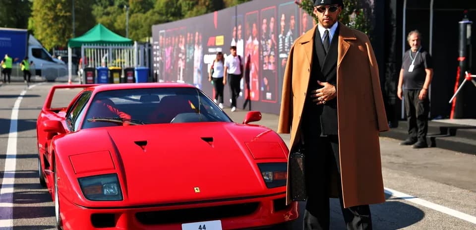 Person in stylish outfit next to red Ferrari F40