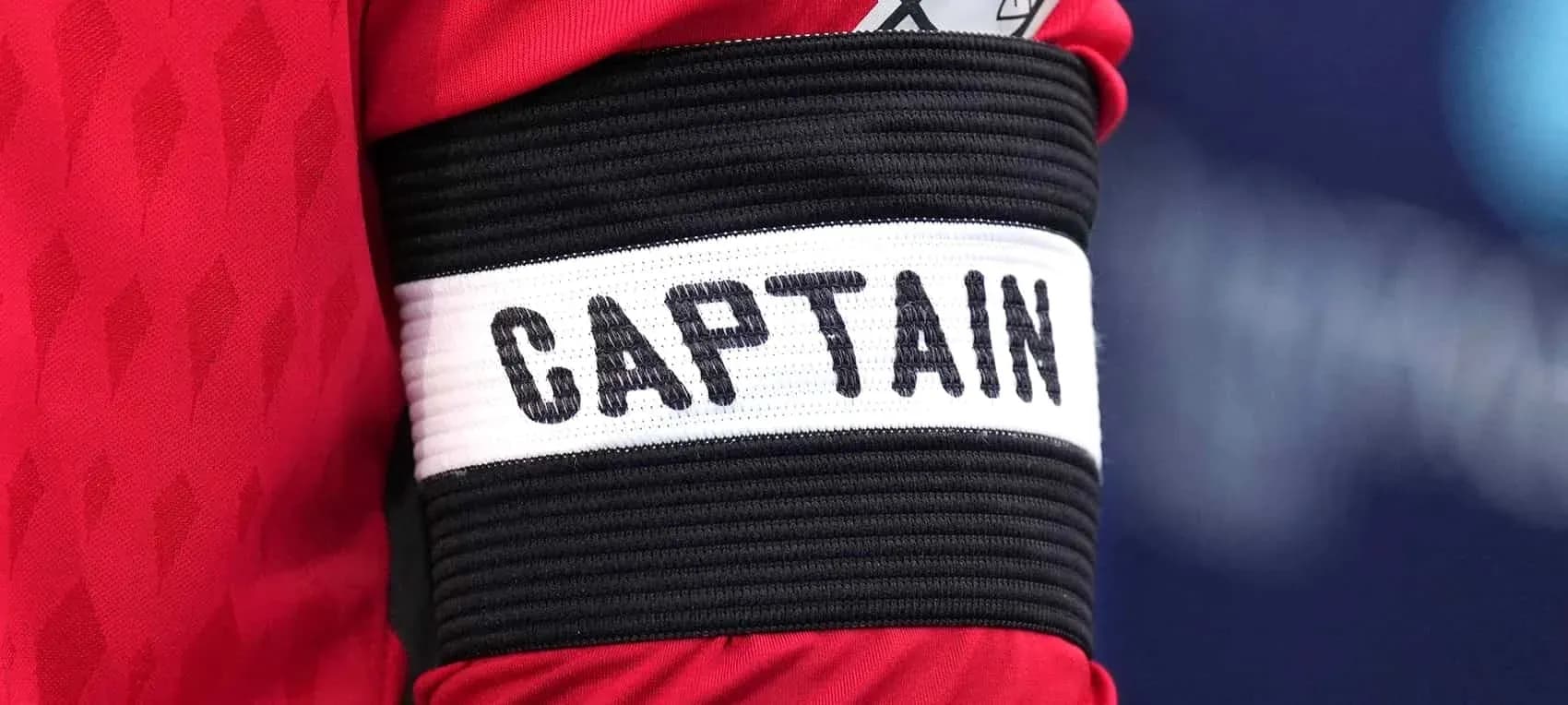 Close-up of a captain's armband with 'CAPTAIN'
