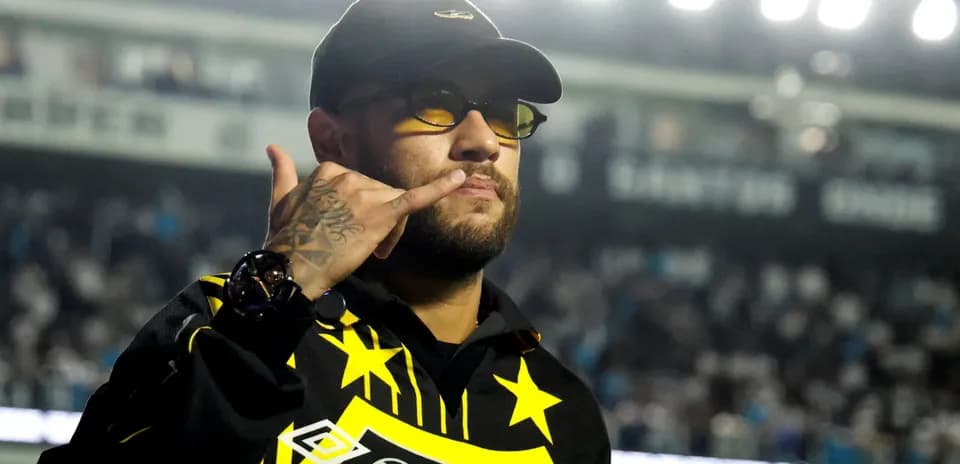 Person making a hand gesture in a stadium