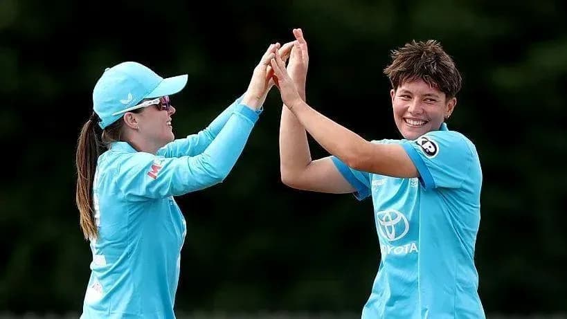 Two players celebrating a wicket during cricket match