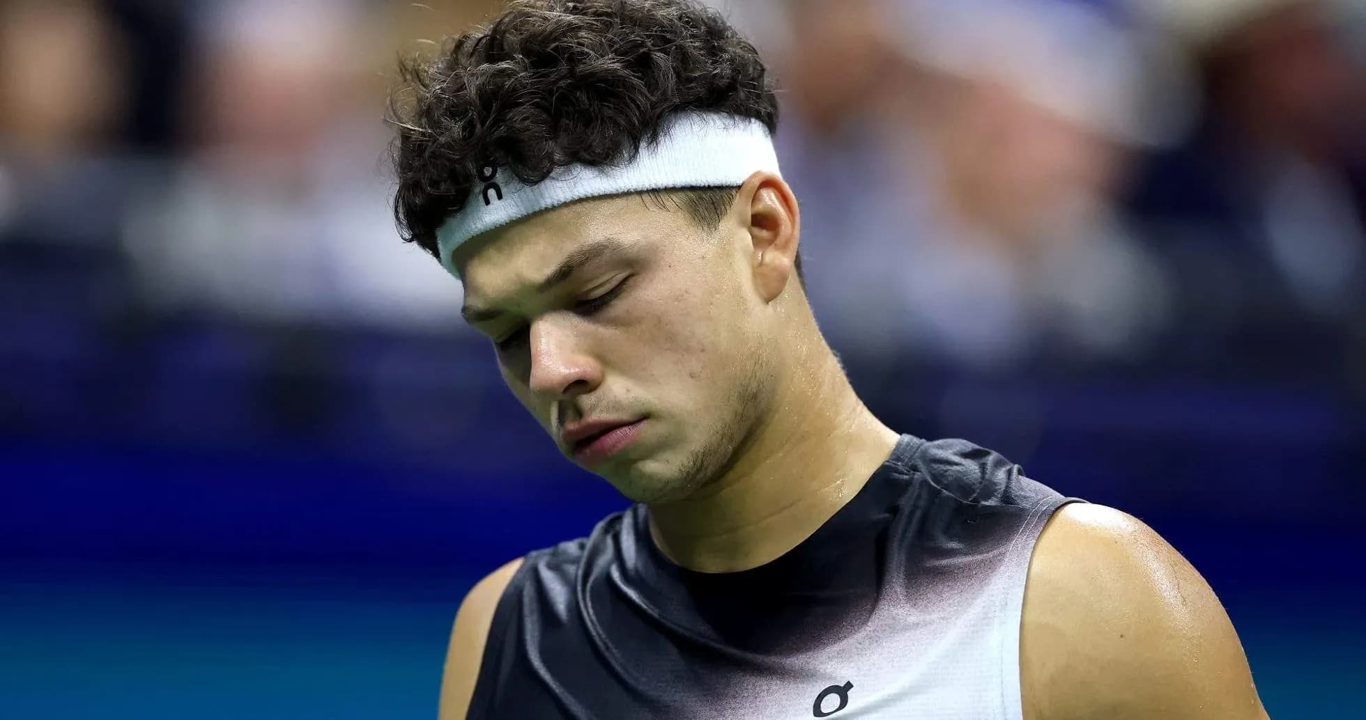 Tennis player looking down on court during match