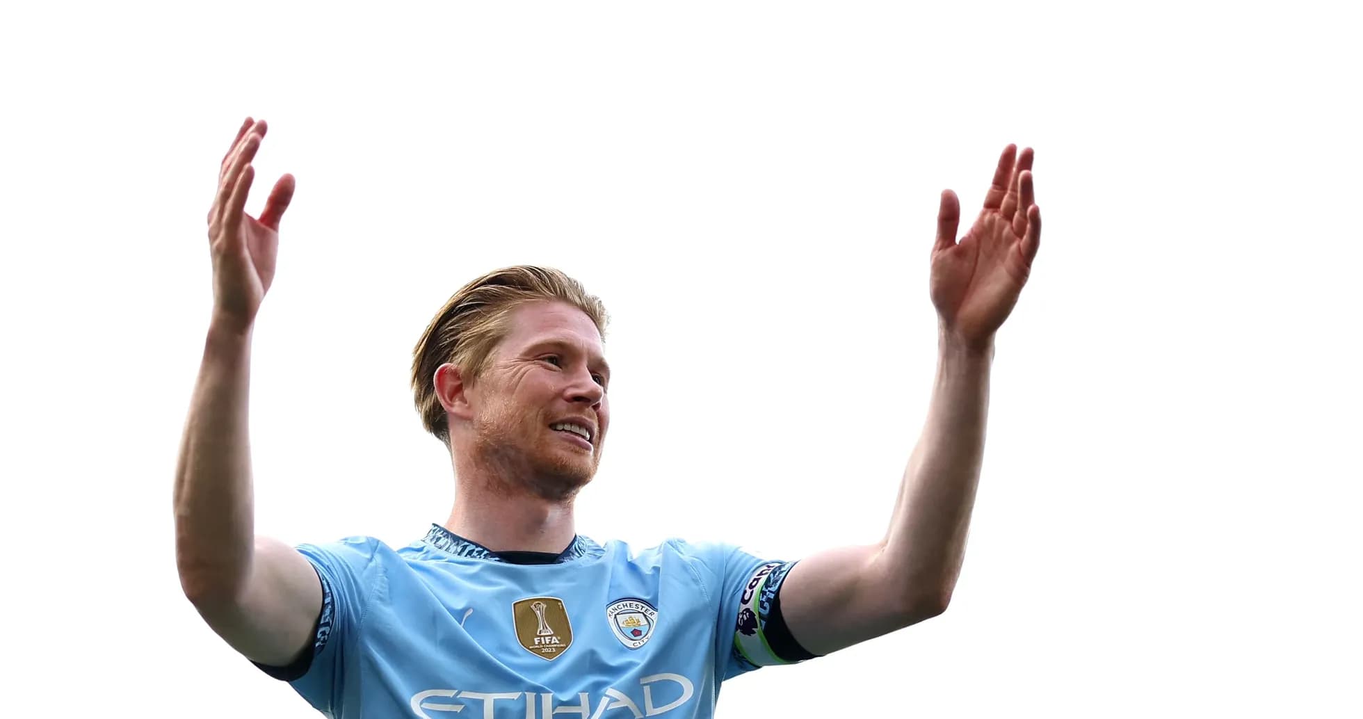 Player celebrating with raised hands on pitch