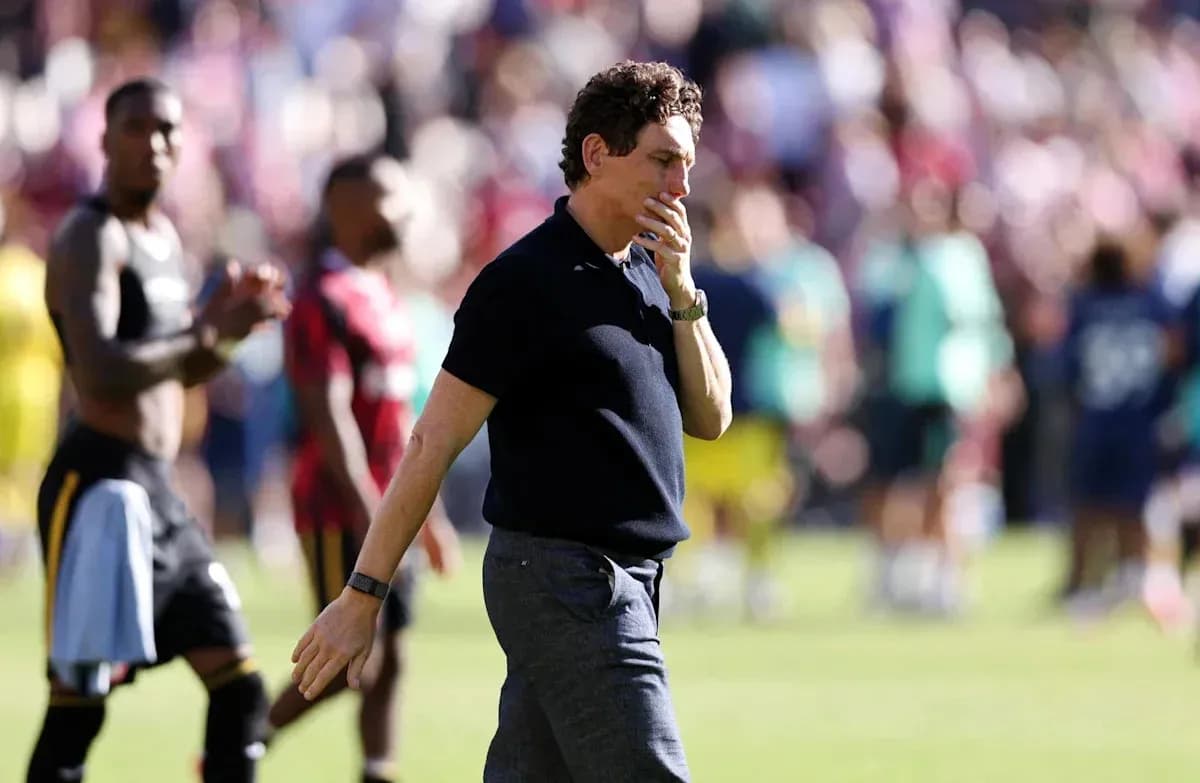 Coach walking off the pitch after match