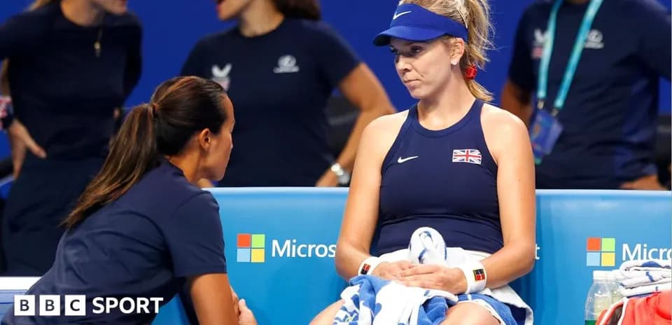 Player sitting on bench receiving coaching advice