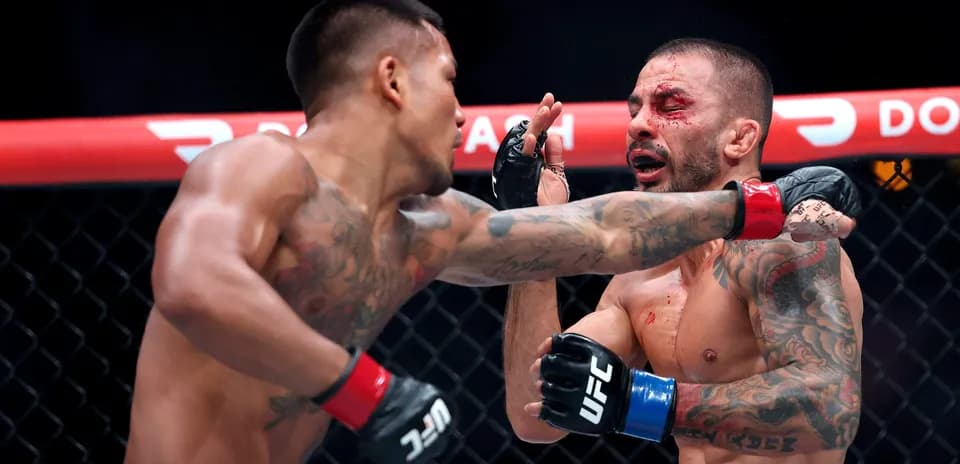Fighter delivering a punch during an MMA match