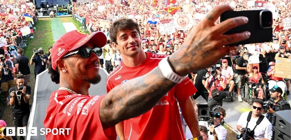 Drivers taking selfie with fans in background