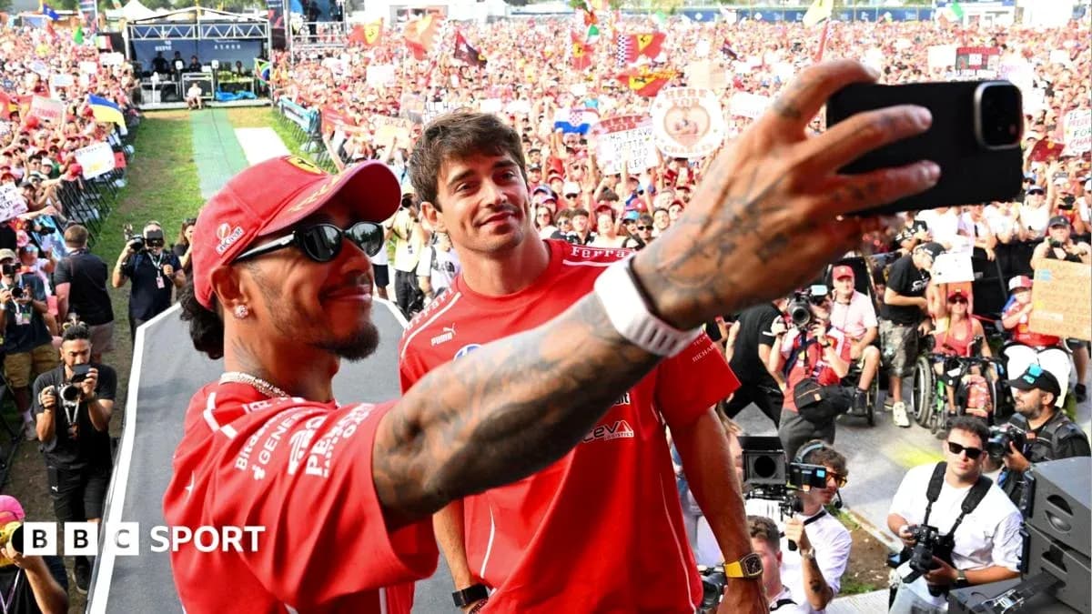 Drivers taking selfie with fans in background