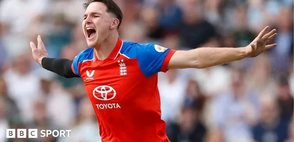 Cricketer celebrating a wicket in red England kit