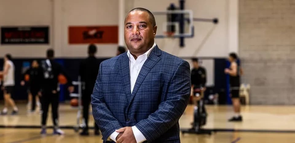 Coach standing in basketball training facility
