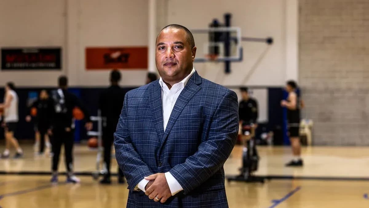 Coach standing in basketball training facility