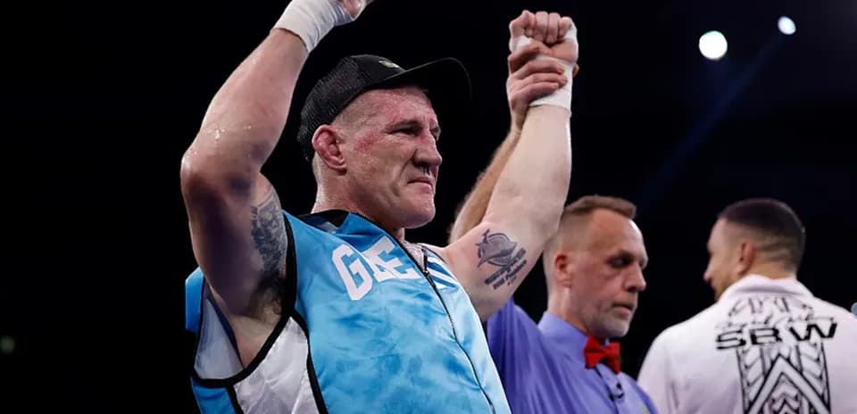 Boxer celebrating victory with raised hands in ring
