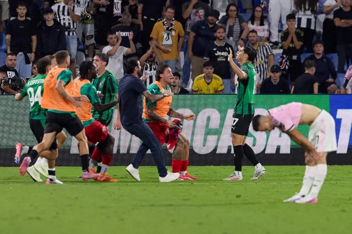 Players celebrating a goal in front of fans