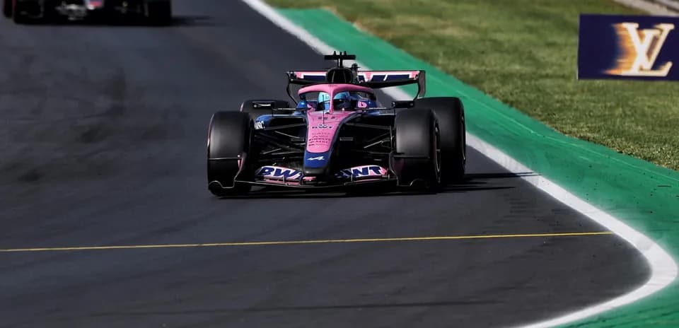 Formula 1 car racing on track with green curbing