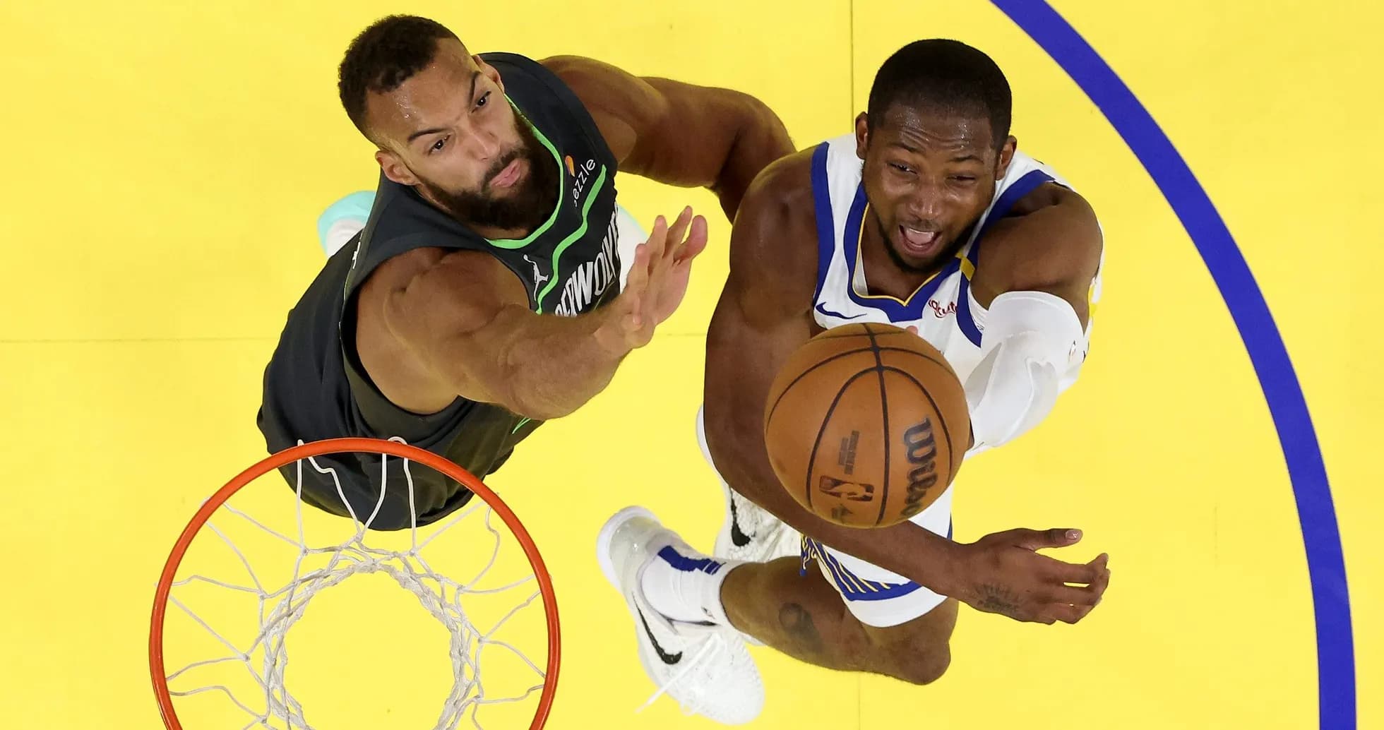 Player shooting the ball with defender nearby