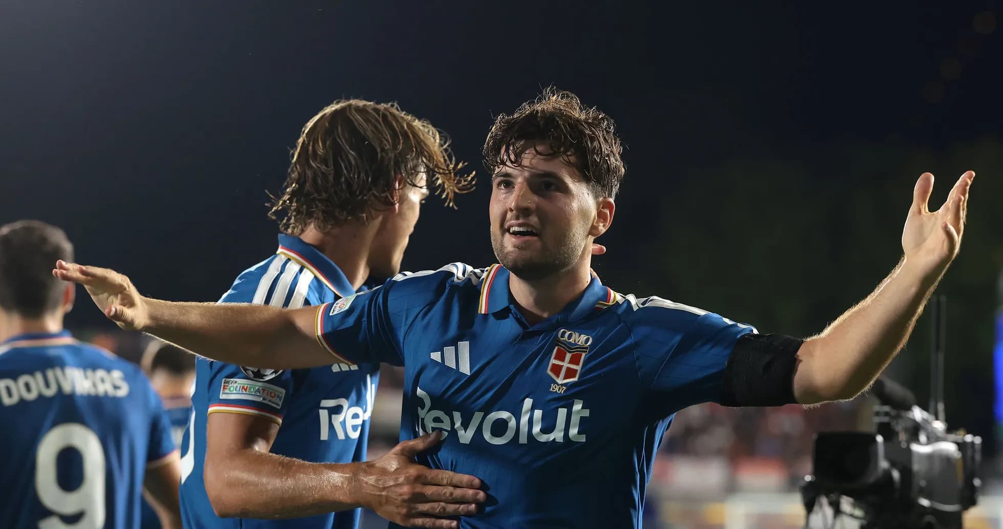 Player celebrating with teammates after scoring a goal