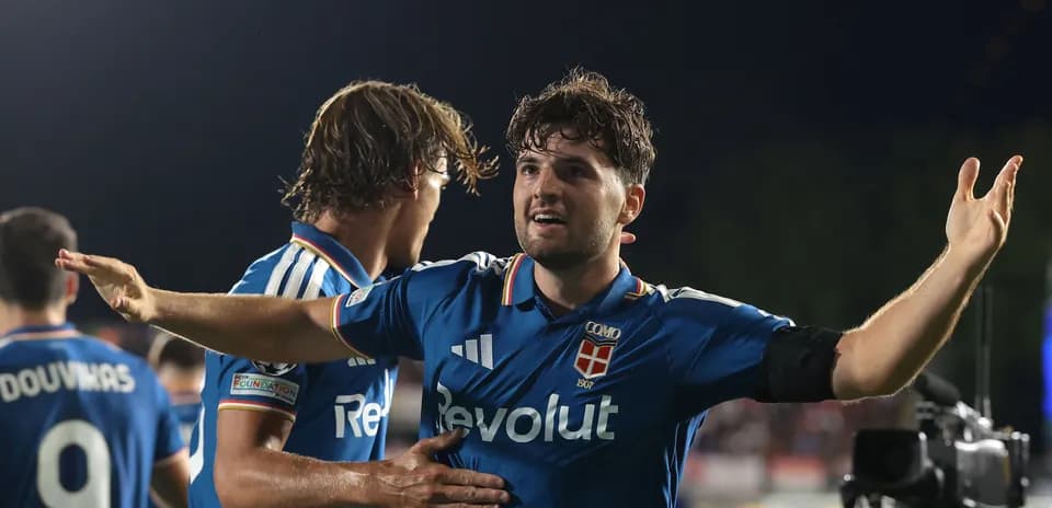Player celebrating with teammates after scoring a goal