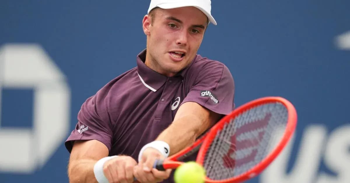 Tennis player hitting a forehand during match
