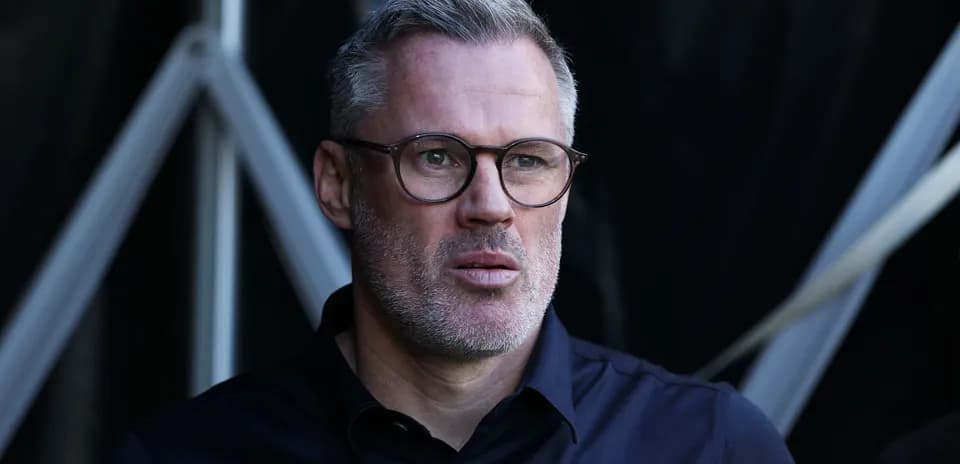 Man with glasses observing from a sports venue