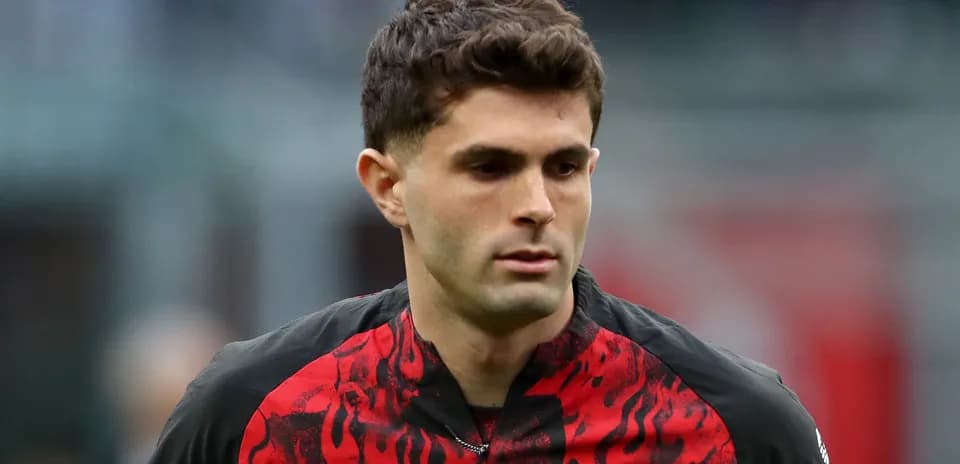 Player in AC Milan jersey during match warm-up