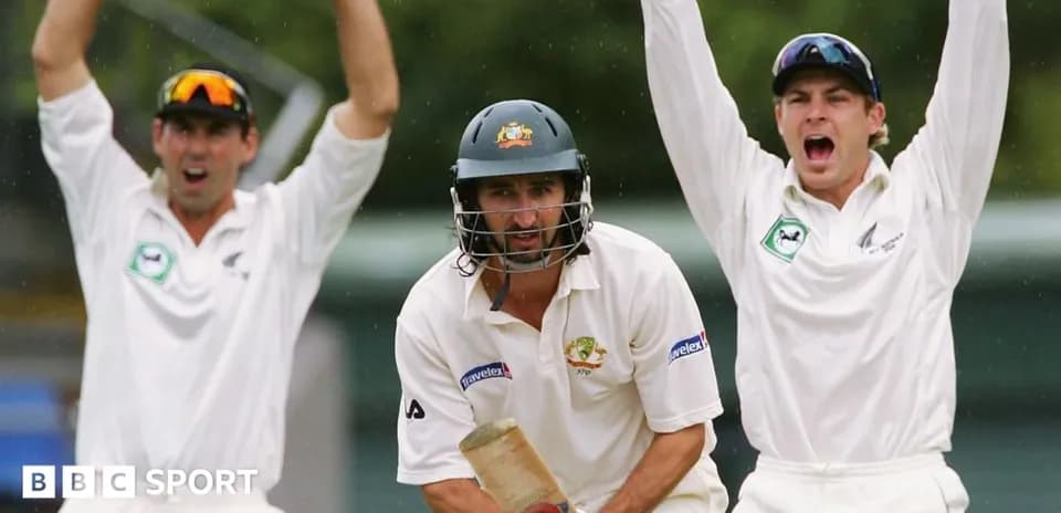 Batsman facing bowlers celebrating a wicket appeal