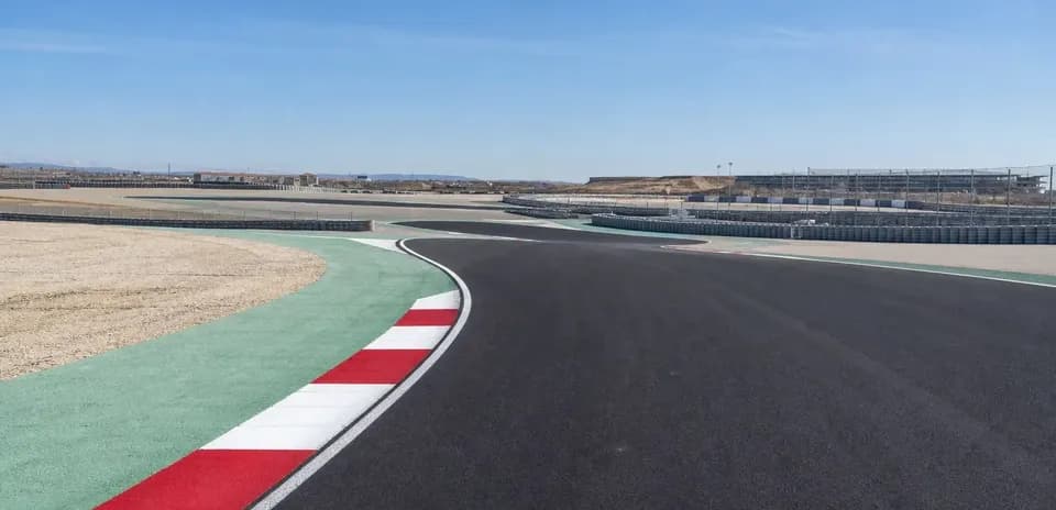 Curved racetrack with colorful curbing and surroundings