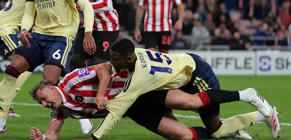 Players tangled on the ground during match action