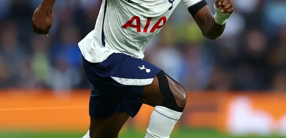 Player running with ball during match for Tottenham
