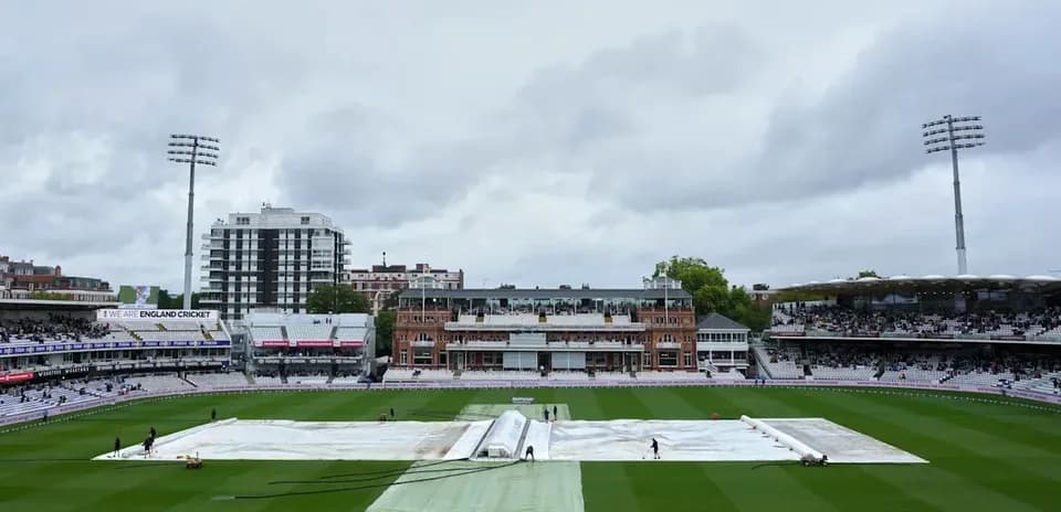 Cricket ground with covers during overcast weather