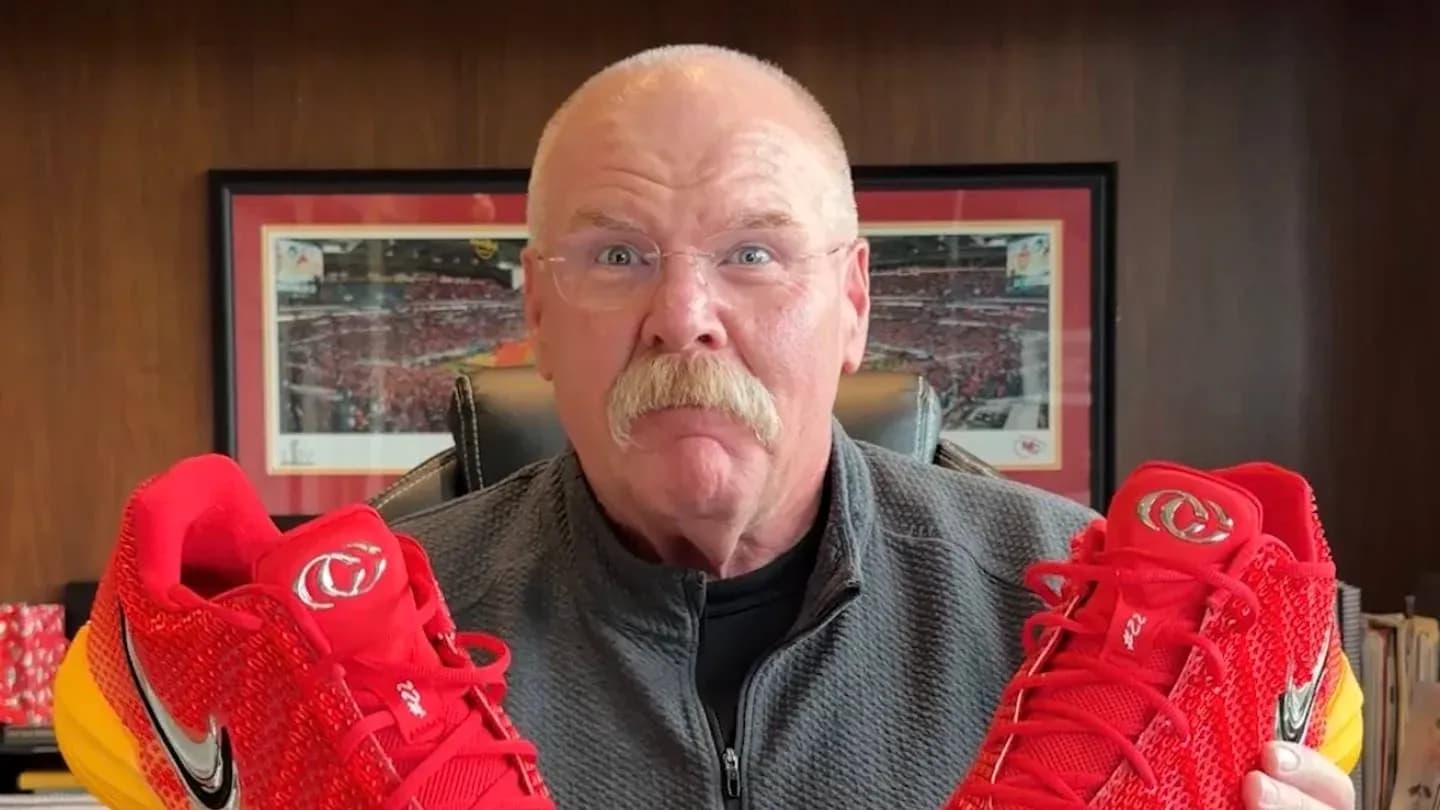Man holding red Nike shoes in office setting