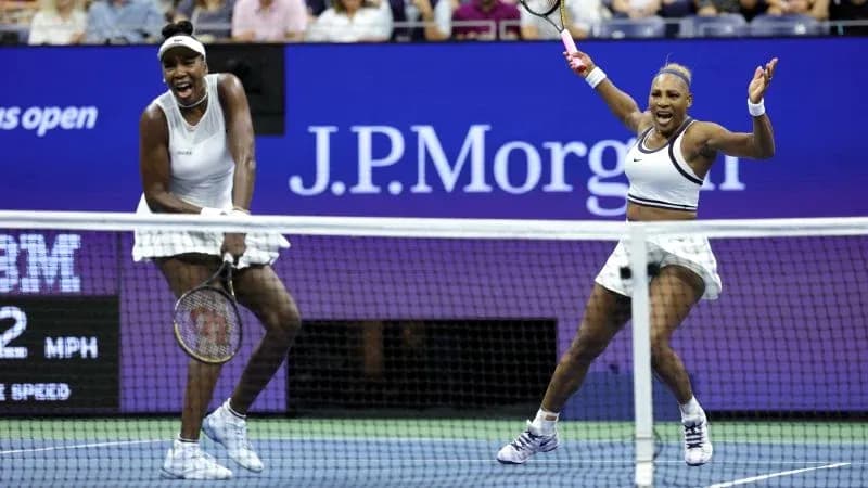 Venus and Serena Williams celebrating during a match Venus and Serena Williams celebrating during a match