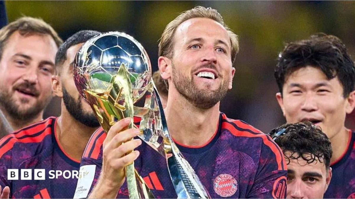 Player holding trophy with teammates celebrating
