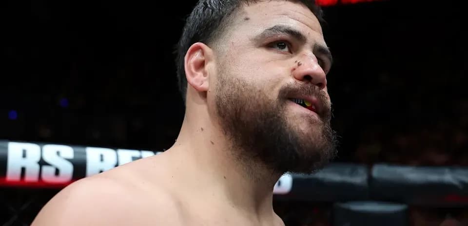 Fighter with mouthguard in MMA cage before match