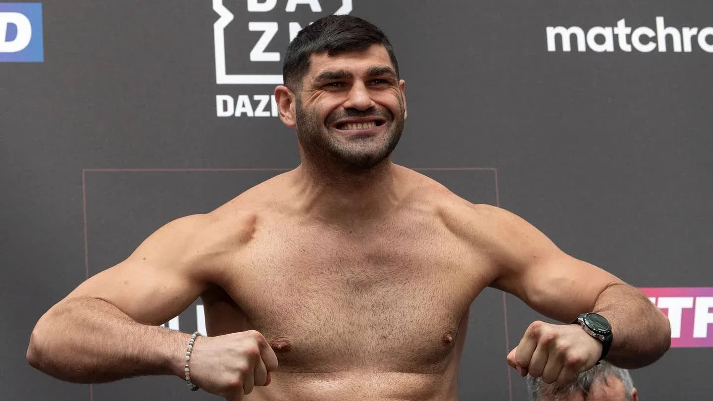 Fighter posing on scale during weigh-in event
