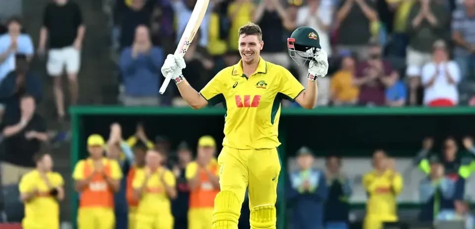 Cricketer celebrating a century with raised bat