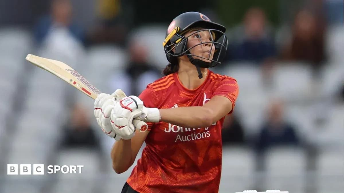 Cricketer batting during a match at the stadium