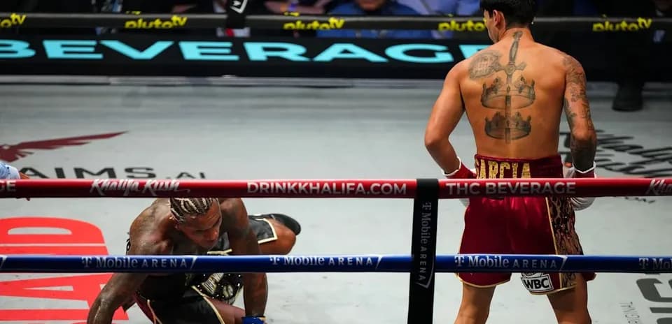 Boxer kneeling on canvas after being knocked down