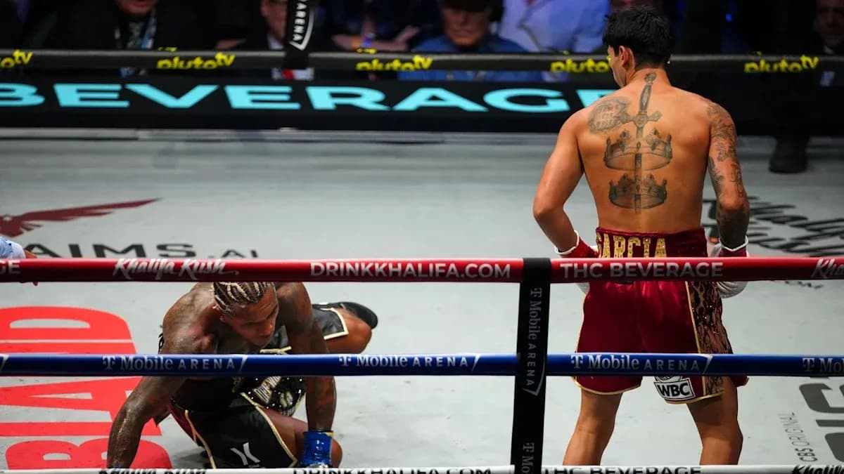 Boxer kneeling on canvas after being knocked down