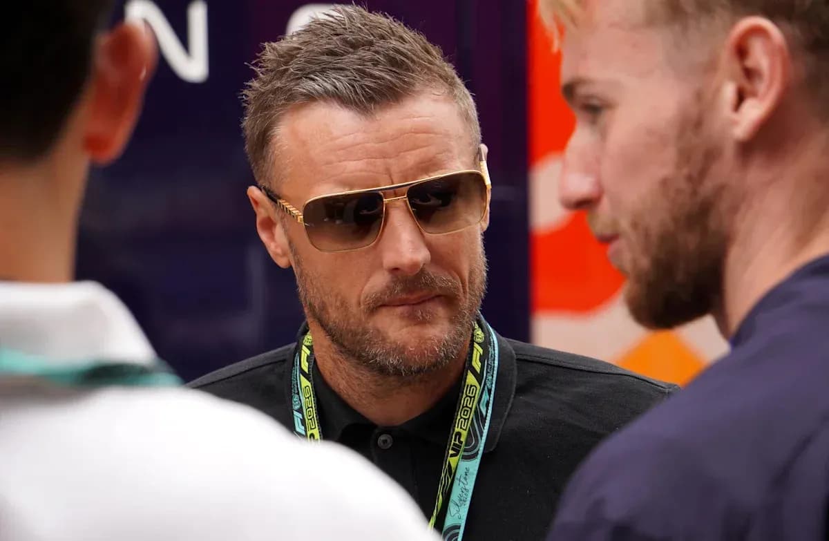 Man wearing sunglasses talking to two others Man wearing sunglasses talking to two others