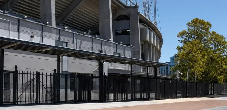 Exterior view of stadium entrance with fencing