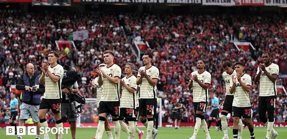 Players applauding fans after a match at Old Trafford