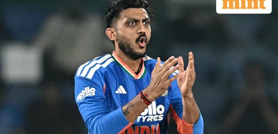 Cricketer in blue jersey clapping during match