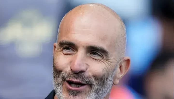 Man with a beard smiling at the camera