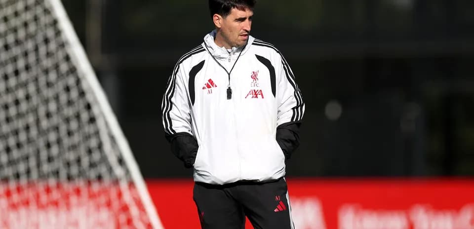 Coach observing players during Liverpool training session