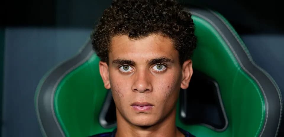 Young athlete sitting in a green gaming chair
