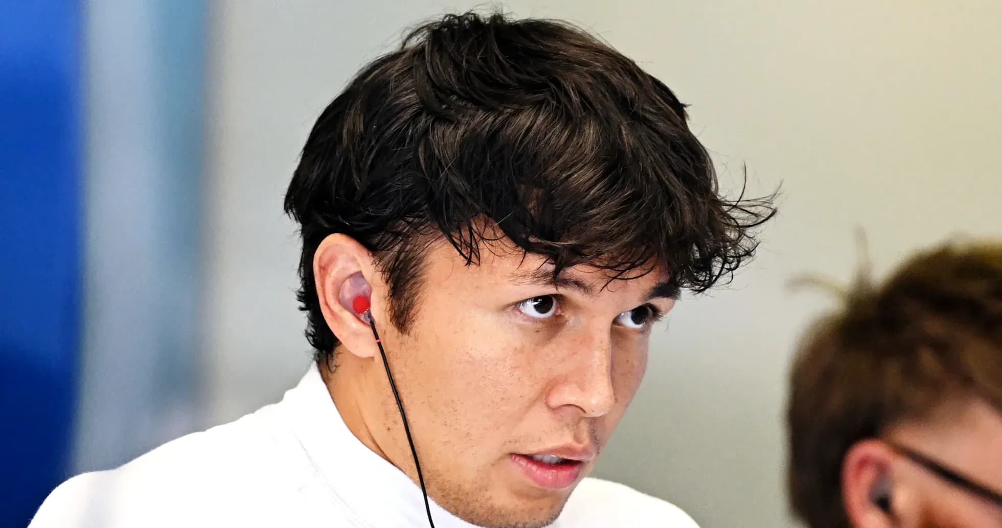 Driver wearing earphones during a briefing session