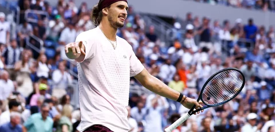 Tennis player gesturing to crowd during match