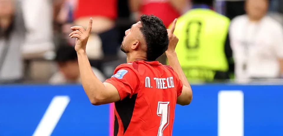 Player celebrating a goal with raised arms