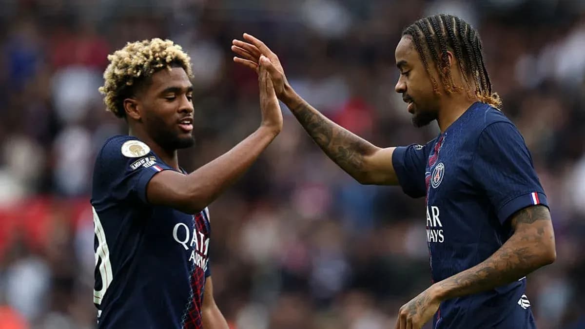 Two PSG players high-fiving during match celebration