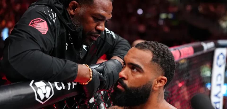 Coach advising fighter in the octagon during match